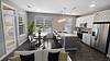 Modern kitchen and dining area with natural light and stylish decor.