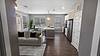 Modern apartment living room and kitchen area with dining space.
