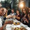 group of friends having a toast at a long table