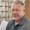 man with short hair and gray shirt