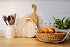 Fruit basket, cutting boards, and utensils on countertop