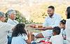 Family having a picnic on blanket outdoors