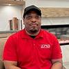 man with baseball cap and polo shirt