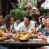 People dining on patio and gathered around table