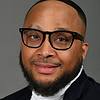 man with beard and black rimmed glasses