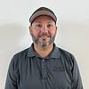 smiling man with short beard and baseball cap
