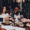 People enjoying a meal and toasting with wine glasses