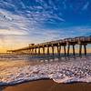 Beach shore with pier and sunset