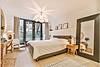 Bedroom with bed, side table, and mirror