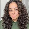woman with curly hair and necklace