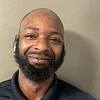smiling man with beard and airpods