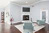 Modern living room with a fireplace, blue walls, and stylish furniture.