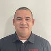 smiling man with short hair and polo shirt