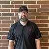 bearded man wearing black shirt and black baseball cap