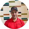 man wearing baseball cap and red shirt