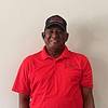 man wearing red shirt and black baseball cap