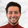 grinning man with gelled hair and stubble