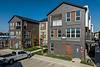 Modern apartment complex with brick exterior and parked truck.