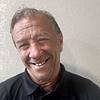 smiling man with short hair and polo shirt
