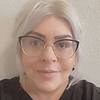 woman with glasses and gold necklace