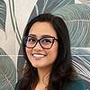 smiling woman with glasses and shoulder-length hair