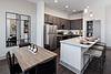 Modern kitchen and dining area with sleek design and stainless steel appliances.