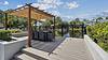 outdoor dining area with a pergola overlooking pond