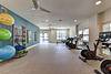 Bright and spacious fitness center with exercise equipment and fitness balls.