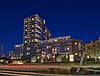 A modern multi-story apartment building illuminated at night.