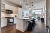 Modern kitchen with stainless steel appliances and a view.