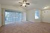 Photo of unfurnished living room with carpet floor and patio access