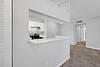 Photo of newly renovatd unit entrance with view of kitchen