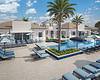 A modern poolside area with lounge chairs, palm trees, and beautiful landscaping.