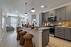 A modern kitchen with a stylish island, seating, and contemporary decor.