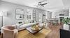 A modern living room with a cozy sofa, dining area, and stylish decor.