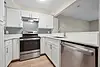 Modern kitchen with white cabinets, stainless steel appliances, and a sleek design.