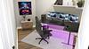 A stylish gaming setup featuring triple monitors, a comfortable chair, and futuristic decor.