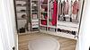 A stylish closet featuring organized clothing and accessories in soft colors.