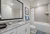 Modern bathroom featuring a sleek design with a tub and stylish countertop.