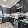 kitchen with dark cabinets and stainless steel appliances