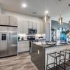 Apartment kitchen with stainless steel appliances and island
